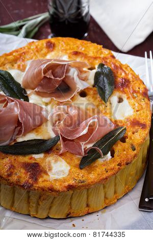 Pasta pie with cheese sauce and sage