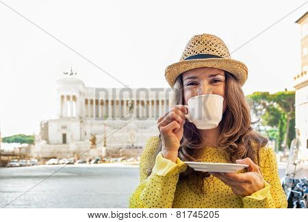 Young Woman Drinking Coffee On Piazza Venezia In Rome, Italy