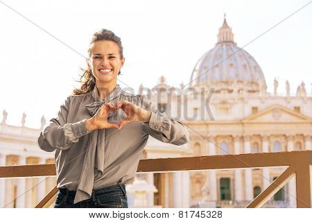 Happy Young Woman Showing Heart Shaped Hands In Front Of Basilic