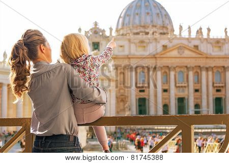 Mother And Baby Girl Pointing On Basilica Di San Pietro In Vatic