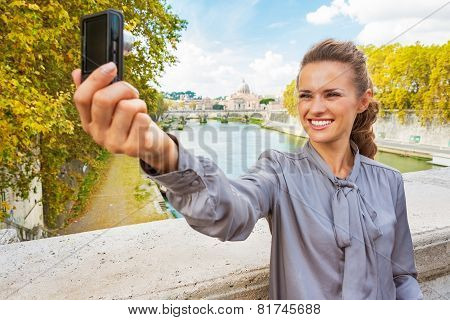 Happy Young Woman Making Selfie While On Bridge Ponte Umberto I With View On Basilica Di San Pietro