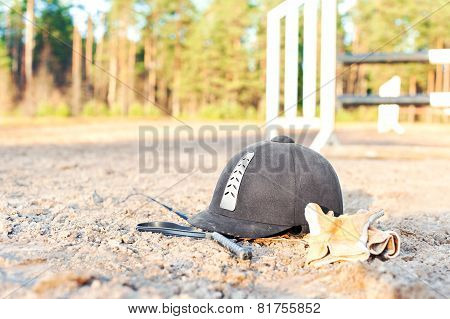 Equestrian Helmet Gloves And Whip Forgotten On The Ground
