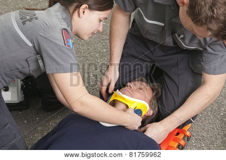 Paramedic employee with ambulance in the background.