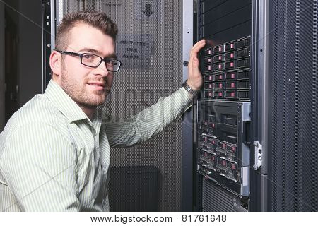 A happy worker technician at work with computer.