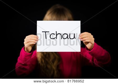 Child Holding Sign With Portuguese Word Tchau - See You Later