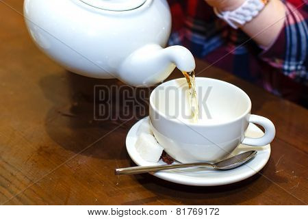Female Hands Poured Green Tea Close-up