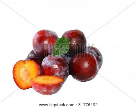 Heap Of Plums With Green Leaf. Isolated.
