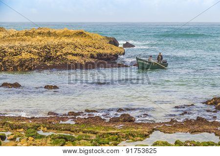 OUALIDIA, MOROCCO, APRIL 6, 2015: Fishermen come back from sea in fishing boat