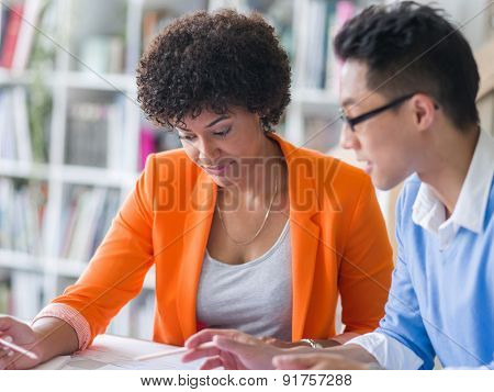 Two desingers working on a project together in office