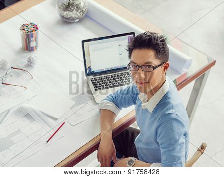 Young chineese engineer working in office