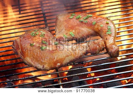 Two Chicken Quarter On The Hot Bbq Grill Close-up.
