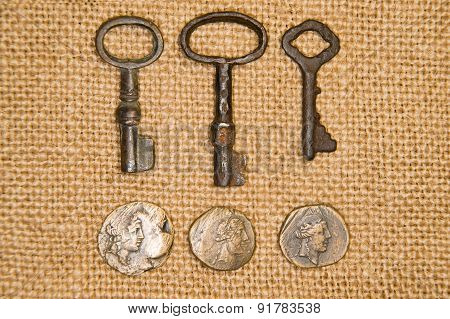 A Lot Vintage Keys From The Locks And Coins On Old Cloth