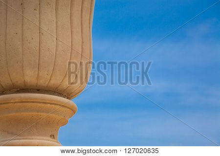 An ancient vase over a blue spring sky