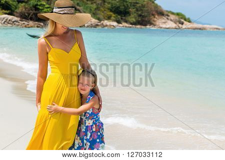 Cute Girl And Beautiful Mother On The Beach