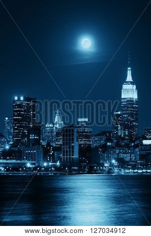 Moon rise over midtown Manhattan with city skyline at night