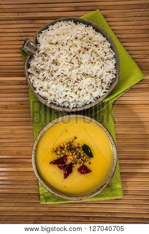 Whole Yellow Lentil with Rice, dal tadka and jeera rice, Indian Dish, cooked rice and cooked Arhar or Toor dal (Pigeon Pea), served in ceramic bowl