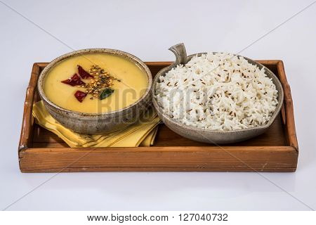 Whole Yellow Lentil with Rice, dal tadka and jeera rice, Indian Dish, cooked rice and cooked Arhar or Toor dal (Pigeon Pea), served in ceramic bowl
