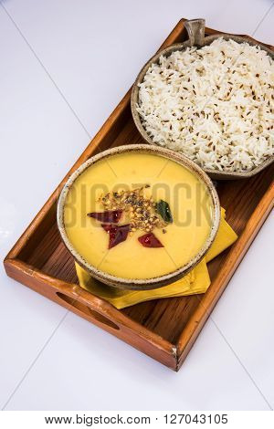 Whole Yellow Lentil with Rice, dal tadka and jeera rice, Indian Dish, cooked rice and cooked Arhar or Toor dal (Pigeon Pea), served in ceramic bowl