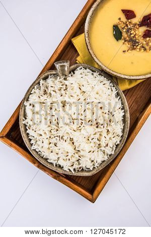 Whole Yellow Lentil with Rice, dal tadka and jeera rice, Indian Dish, cooked rice and cooked Arhar or Toor dal (Pigeon Pea), served in ceramic bowl