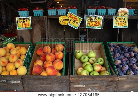 Fruits in wooden lugs for sell at farmers market.