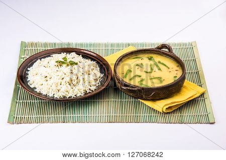Whole Yellow Lentil with Rice, dal tadka and jeera rice, Indian Dish, cooked rice and cooked Arhar or Toor dal (Pigeon Pea), served in ceramic bowl