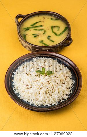 Whole Yellow Lentil with Rice, dal tadka and jeera rice, Indian Dish, cooked rice and cooked Arhar or Toor dal (Pigeon Pea), served in ceramic bowl