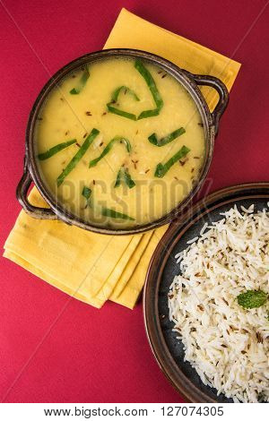 Whole Yellow Lentil with Rice, dal tadka and jeera rice, Indian Dish, cooked rice and cooked Arhar or Toor dal (Pigeon Pea), served in ceramic bowl