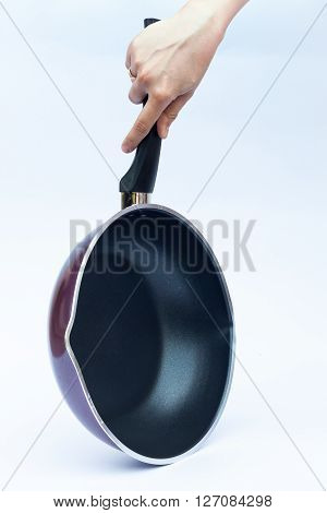 Hand with non stick frying pan on white background, stock photo
