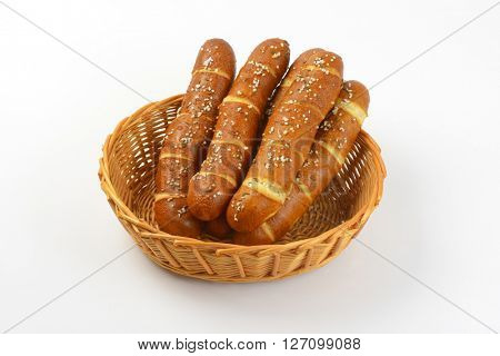 scuttle of fresh bread rolls on white background