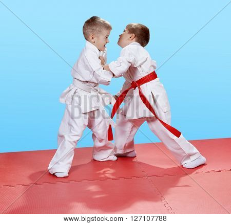 Judo sparring in perfoming young athletes on the mats