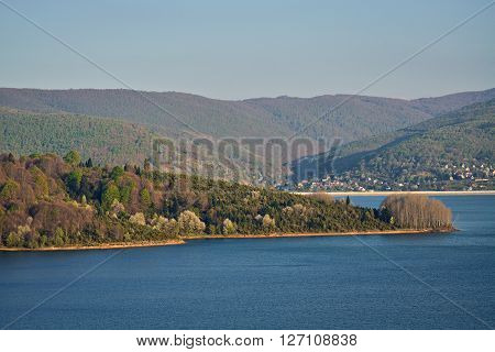 Beautiful Debar lake and dense forest during the sunset