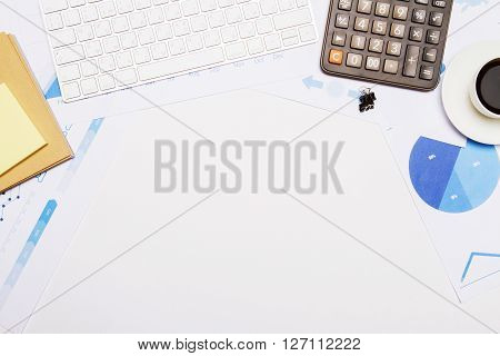 Topview of white desk with office tools and empty space. Mock up