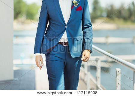Wallking groom. Details of the suite without face