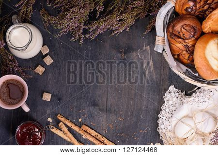Bakery background with eggs, milk, sugar and sweet confectionery. Wooden background, copy space, top view.