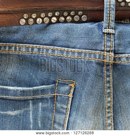 blue jeans with brown leather belt, clothing industry
