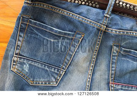 blue jeans with brown leather belt, clothing industry