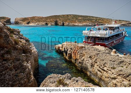BLUE LAGOON/ COMINO ISLAND / MALTA /APRIL 13 2016 : Ferry Boat parked in the island of Comino Malta.
