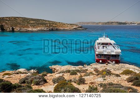 BLUE LAGOON/ COMINO ISLAND / MALTA /APRIL 13 2016 : Ferry parked next to the shore  on the island of Comino Malta.