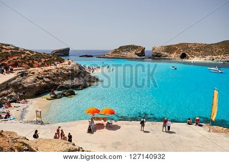 BLUE LAGOON/ COMINO ISLAND / MALTA /APRIL 13 2016 : People enjoying the sun and blue waters on the beach.