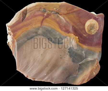 Raw orange and brown flint mineral macro isolated on black background