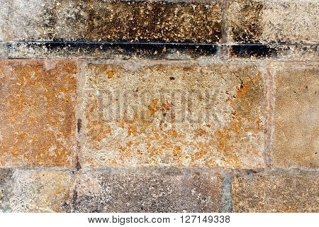 old wall of sandstone slabs for background