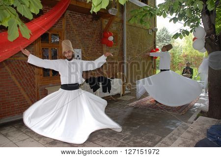 ANKARA/TURKEY-MAY 8, 2015: Sufi whirling dervish (Semazen) dances at the garden of YEKAD Association's cultural event. May 8, 2015-Ankara/Turkey