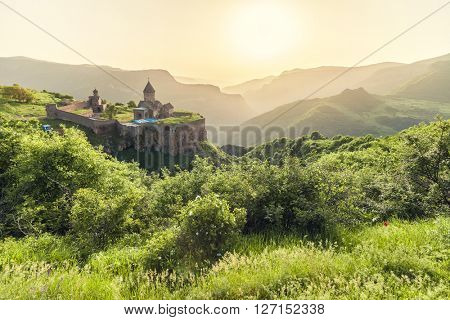 Ancient monastery in setting sun. Tatev. Armenia