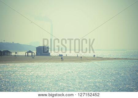 The beach Delilah in Ashkelon, the Mediterranean Sea. A strip of beach and people away. Toning.