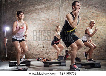 step group training, smiling people doing exercise