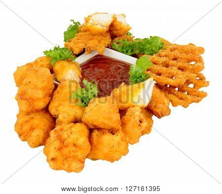 Group of fried battered chicken nugget bites and lattice fries with tomato dipping sauce isolated on a white background