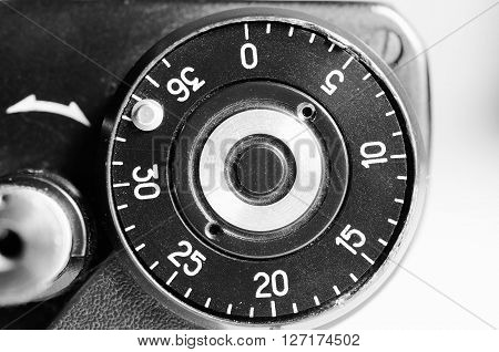 Fragment of old film camera. Top view of shutter button and the frame counter. Close up view. Macro. Selective focu. sVintage photo. Toning.