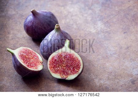 Fresh ripe organic figs on brown background