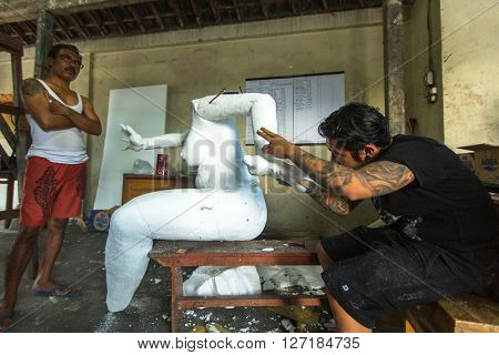 BALI, INDONESIA - FEB 24, 2016: Unidentified local people during built Ogoh-ogoh are statues for the Ngrupuk parade, which takes place on the eve of Nyepi day. Nyepi is a public holiday in Indonesia.