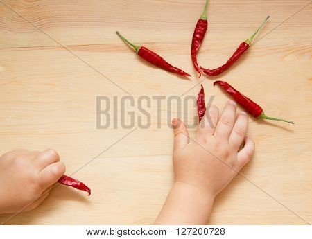 Six Pieces Of Red Hot Chili Peppers Over Wooden Background